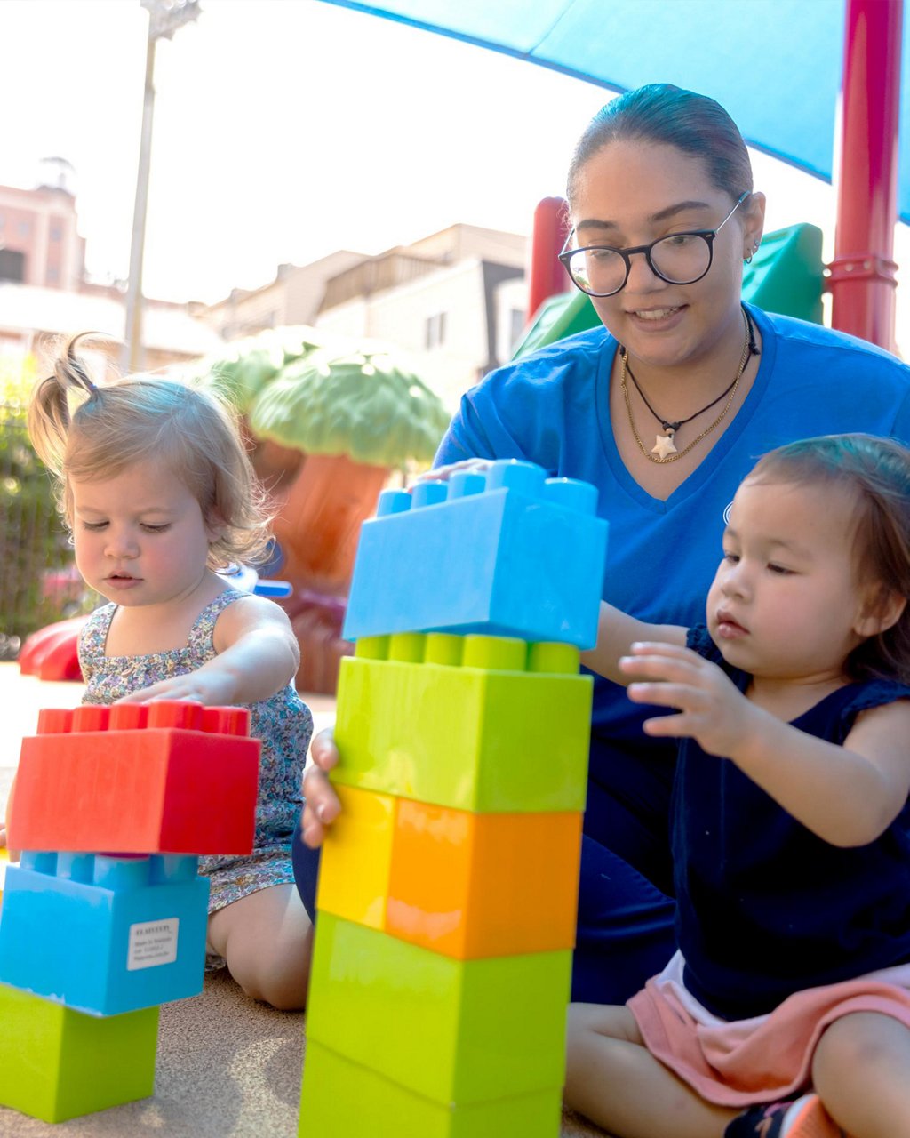 Children playing with large blocks on a playground