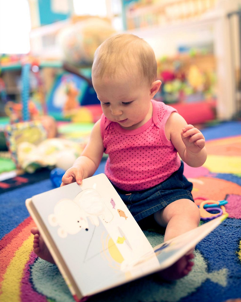 A young child looking at a picture book 