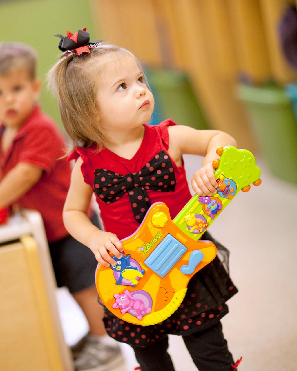 A child playing a toy guitar 