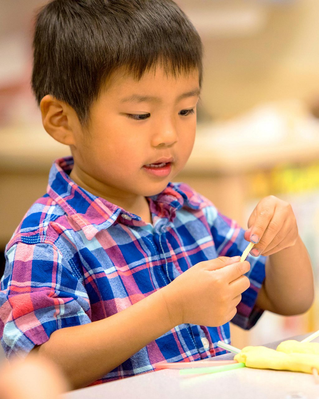 A child playing with clay 