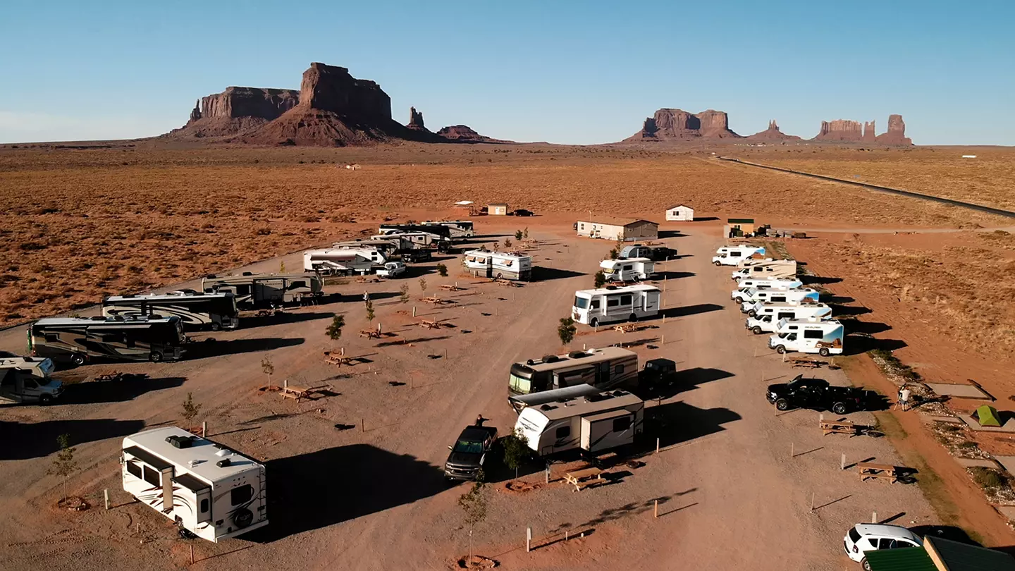 Aerial view of campers and RVs parked in a campground in the desert. 