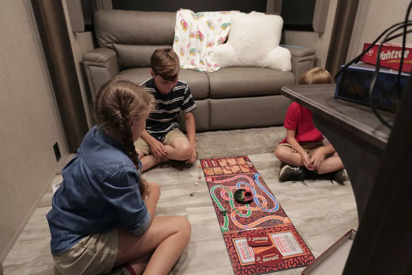 Children gathered on the floor playing a board game.