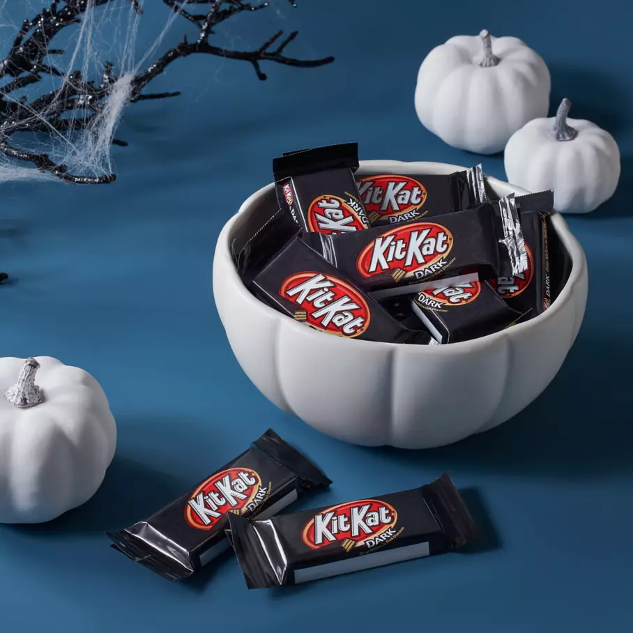 White pumpkin bowl full of kit kat halloween dark chocolate snack size candy bars