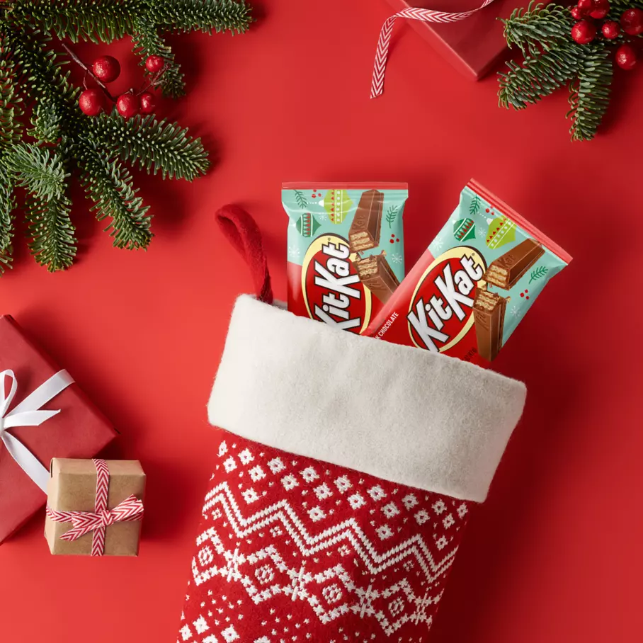 christmas stocking filled with packs of kit kat holiday milk chocolate candy bars