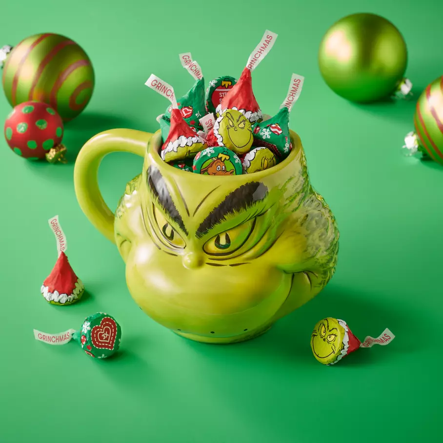 grinch themed mug filled with hersheys kisses milk chocolates with grinch foils candy