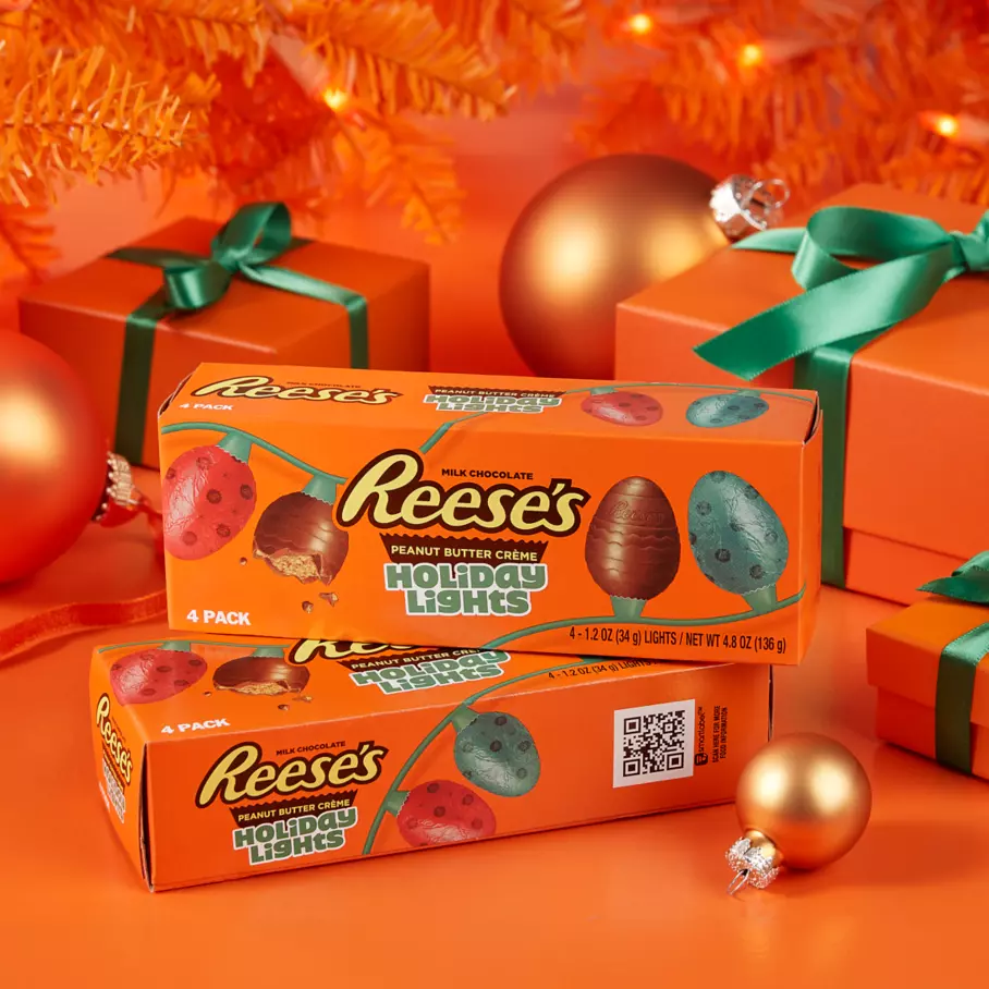 packs of reeses milk chocolate peanut butter creme holiday lights under christmas tree