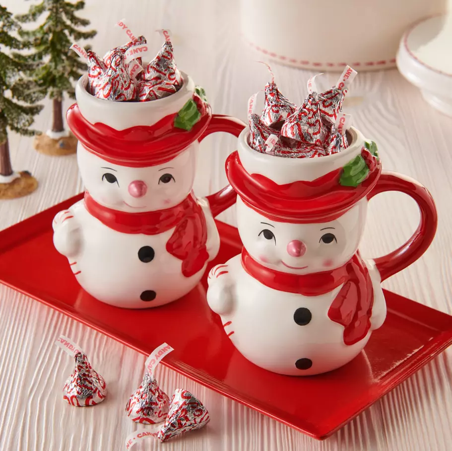 two snowman mugs filled with hersheys kisses candy cane mint candy