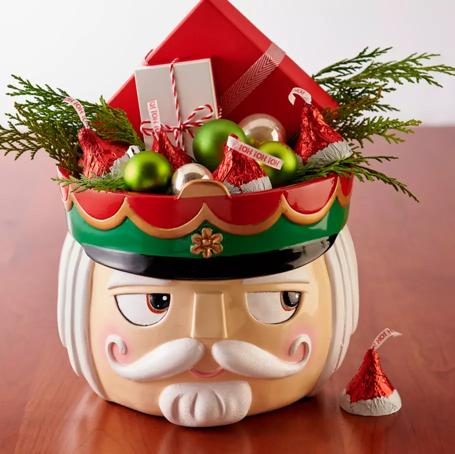 nutcracker themed bowl filled with ornaments and hersheys kisses santa hat foils milk chocolate candy