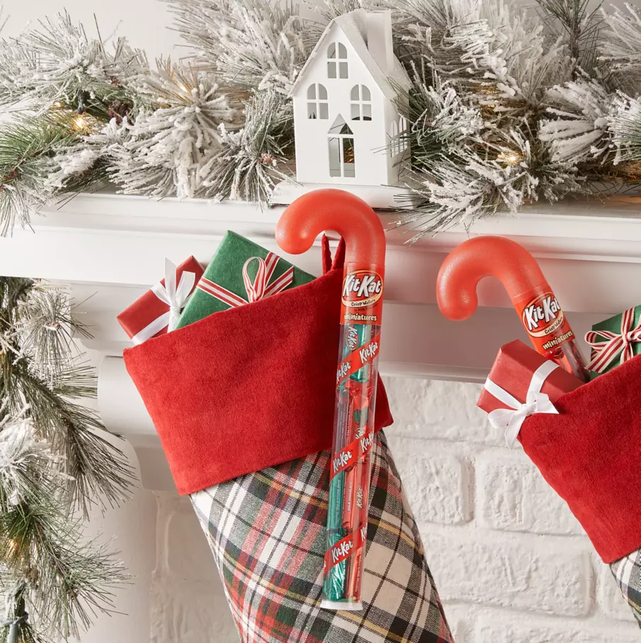 candy canes filled with kit kat holiday milk chocolate miniatures candy bars hanging from christmas stockings