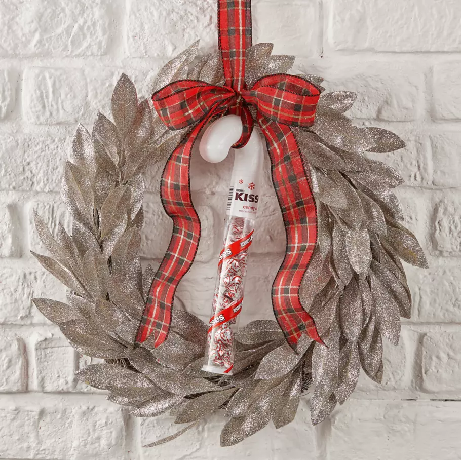 HERSHEY'S KISSES Candy Cane hanging from a Christmas wreath