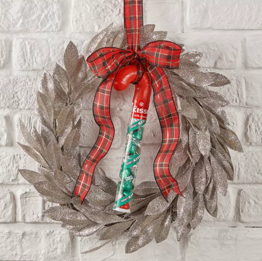 HERSHEY'S KISSES Candy Cane hanging from a Christmas wreath