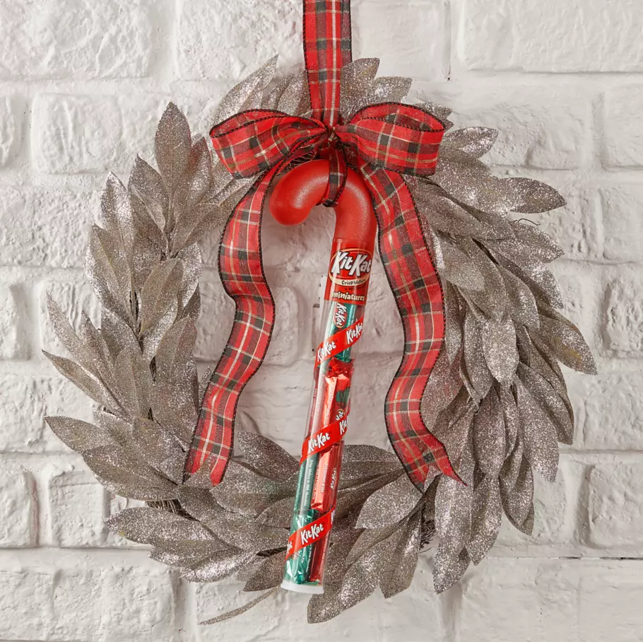 KIT KAT® Holiday Candy Cane hanging from Christmas wreath