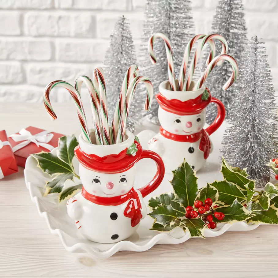 HERSHEY'S Holiday Candy Canes inside two snowmen mugs