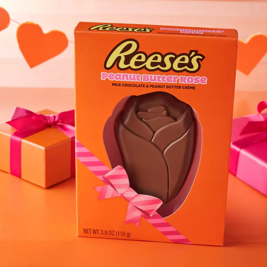 reeses milk chocolate peanut butter creme rose package beside wrapped gifts