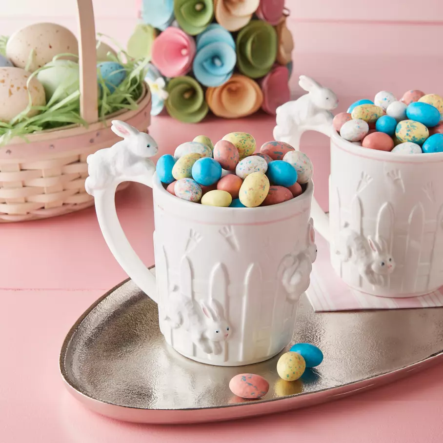 two bunny themed mugs filled with whoppers robin eggs malted milk balls