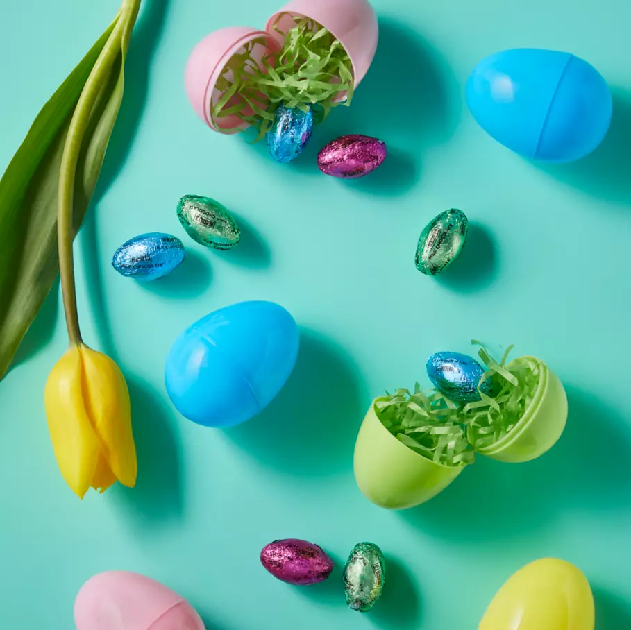 HERSHEY'S Milk Chocolate Eggs surrounded by flowers and plastic Easter Eggs