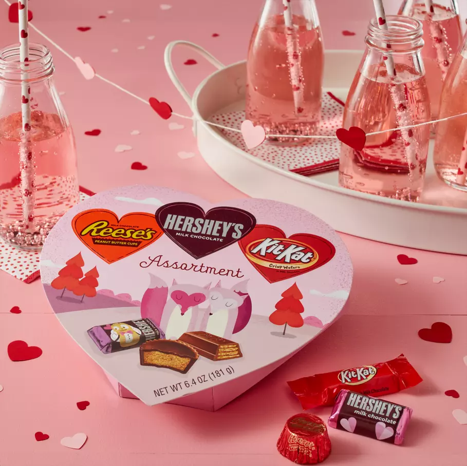 Hershey Valentine's Assortment Package on decorative table with paper hearts
