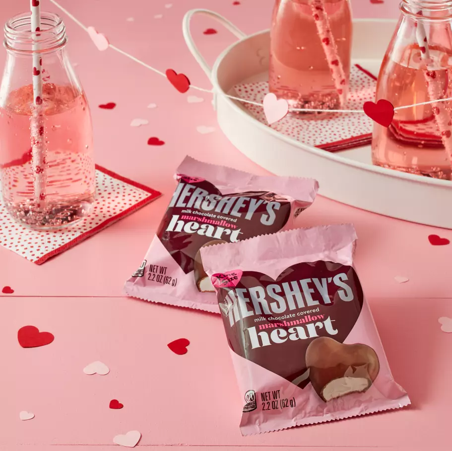 HERSHEY'S Milk Chocolate Marshmallow Hearts on decorative table with paper hearts