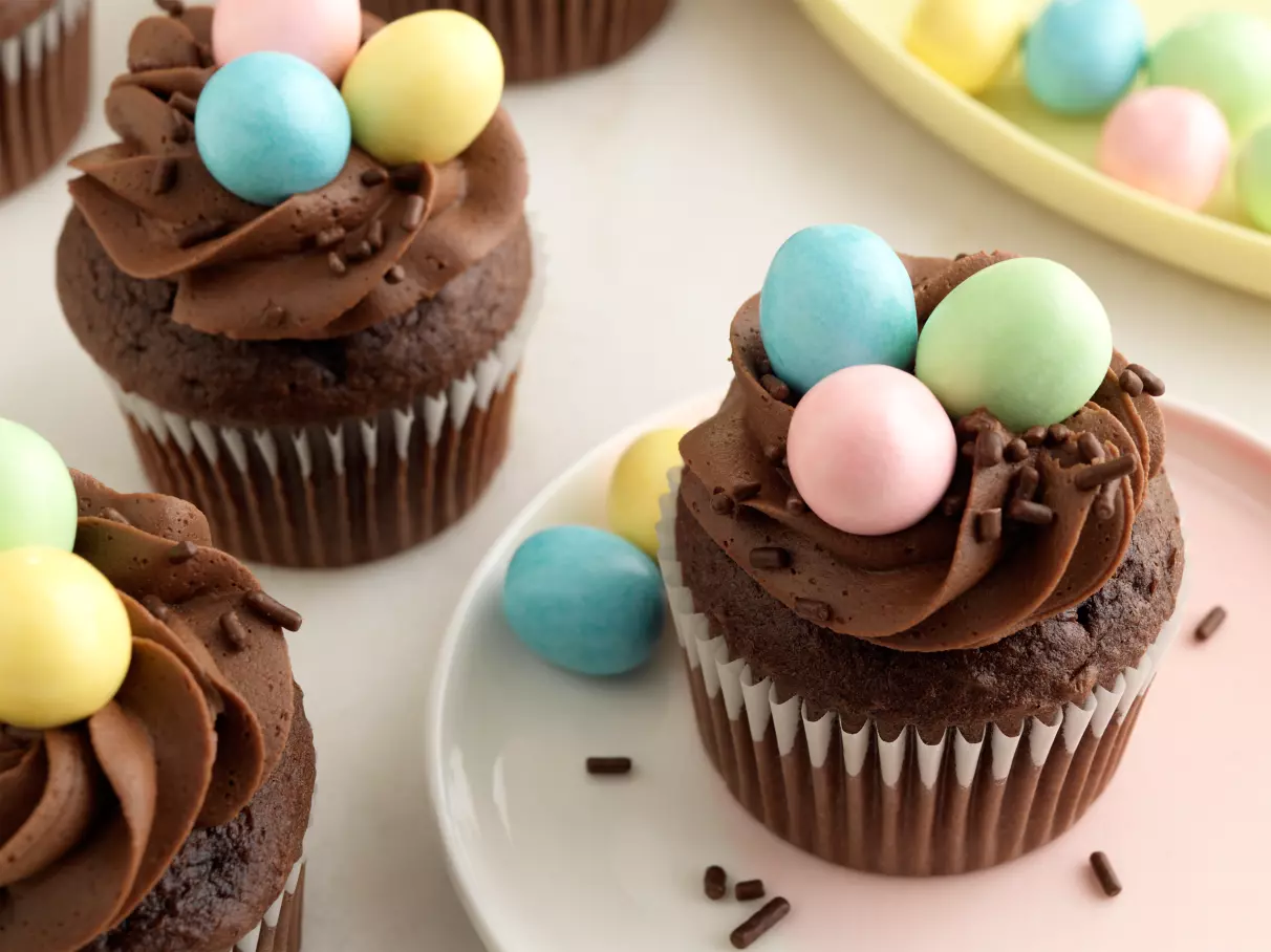 batch of hersheys perfectly chocolate chocolate cupcakes topped with candy coated eggs