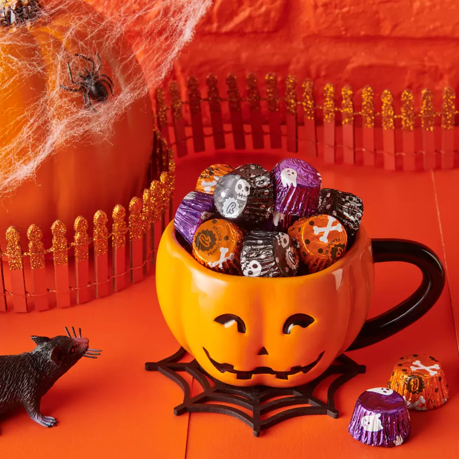 Pumpkin mug filled with reeses miniatures milk chocolate peanut butter cups