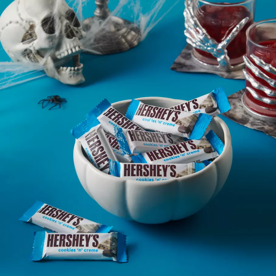 White pumpkin bowl full of hersheys cookies and creme snack size candy bars