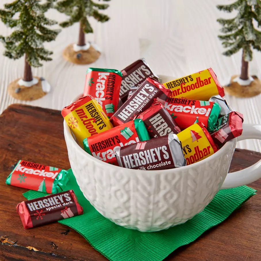 holiday themed mug filled with assorted hersheys holiday miniatures candy