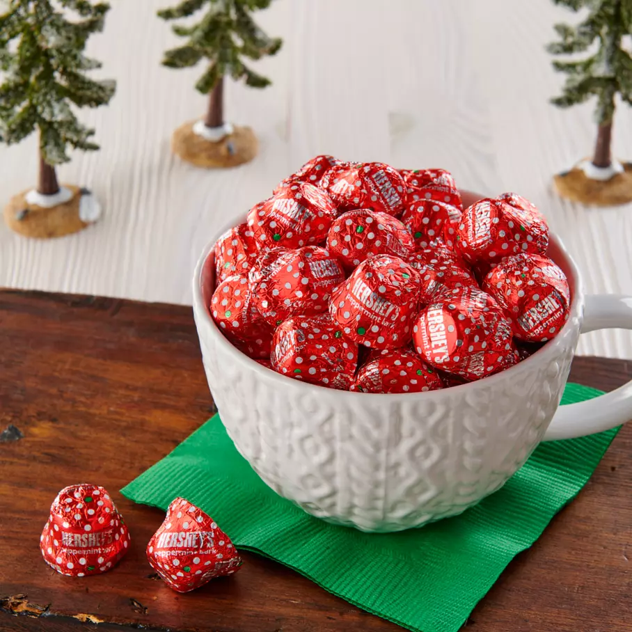 Christmas mug full of HERSHEY'S Peppermint Bark Bells Candy