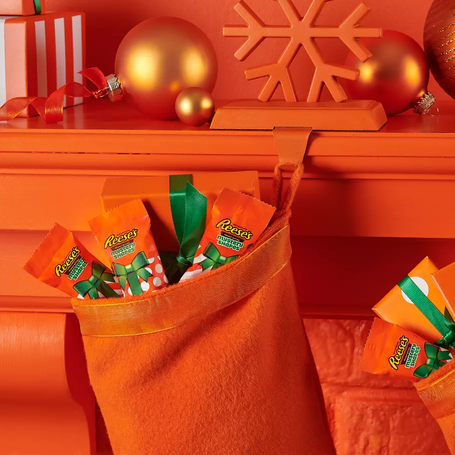 christmas stocking filled with packs of reeses holiday snack size mystery shapes