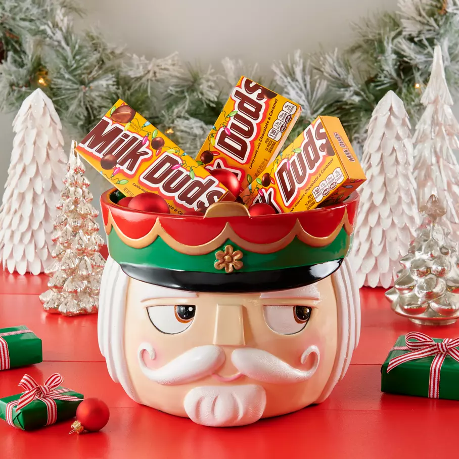 nutcracker themed bowl filled with packs of milk duds holiday chocolate and caramel candy