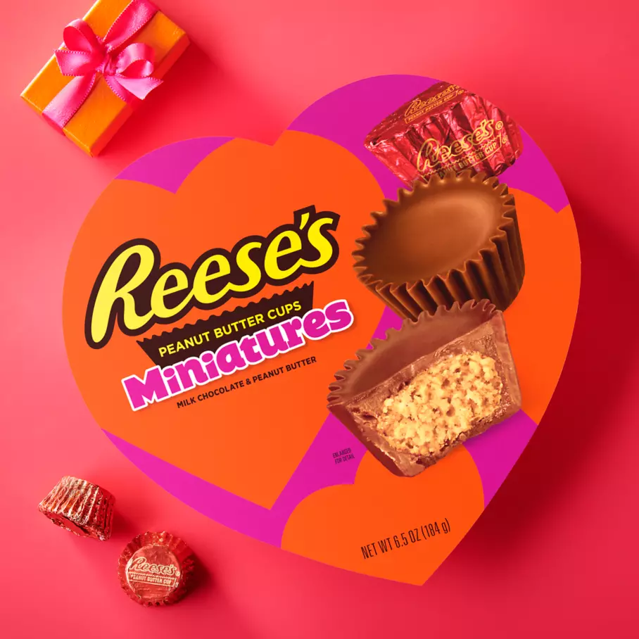 Package of REESE'S Milk Chocolate Miniatures Peanut Butter Cups beside gift box