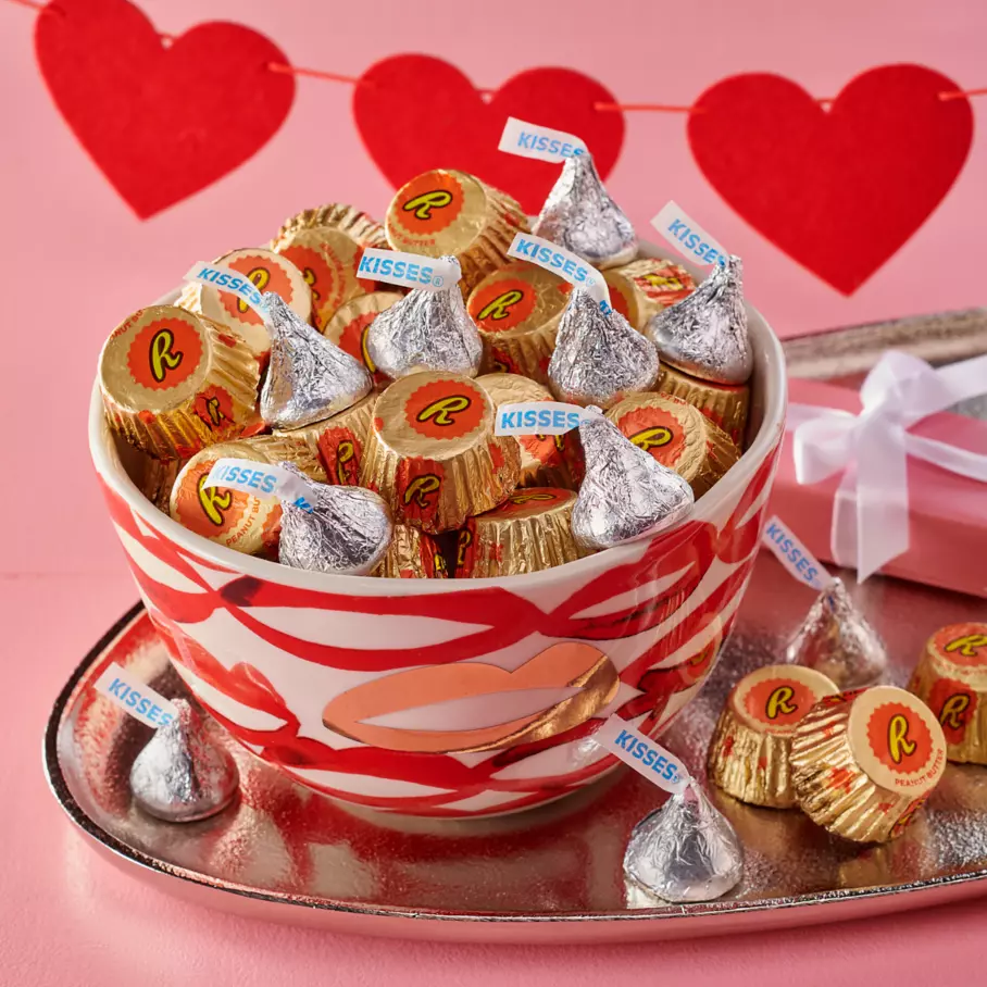 decorative bowl filled with hershey kisses milk chocolates and reeses miniatures peanut butter cups