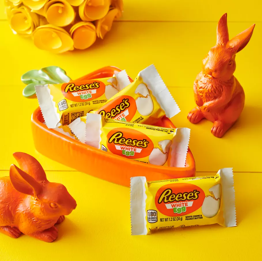carrot shaped bowl filled with packs of reeses white creme peanut butter eggs