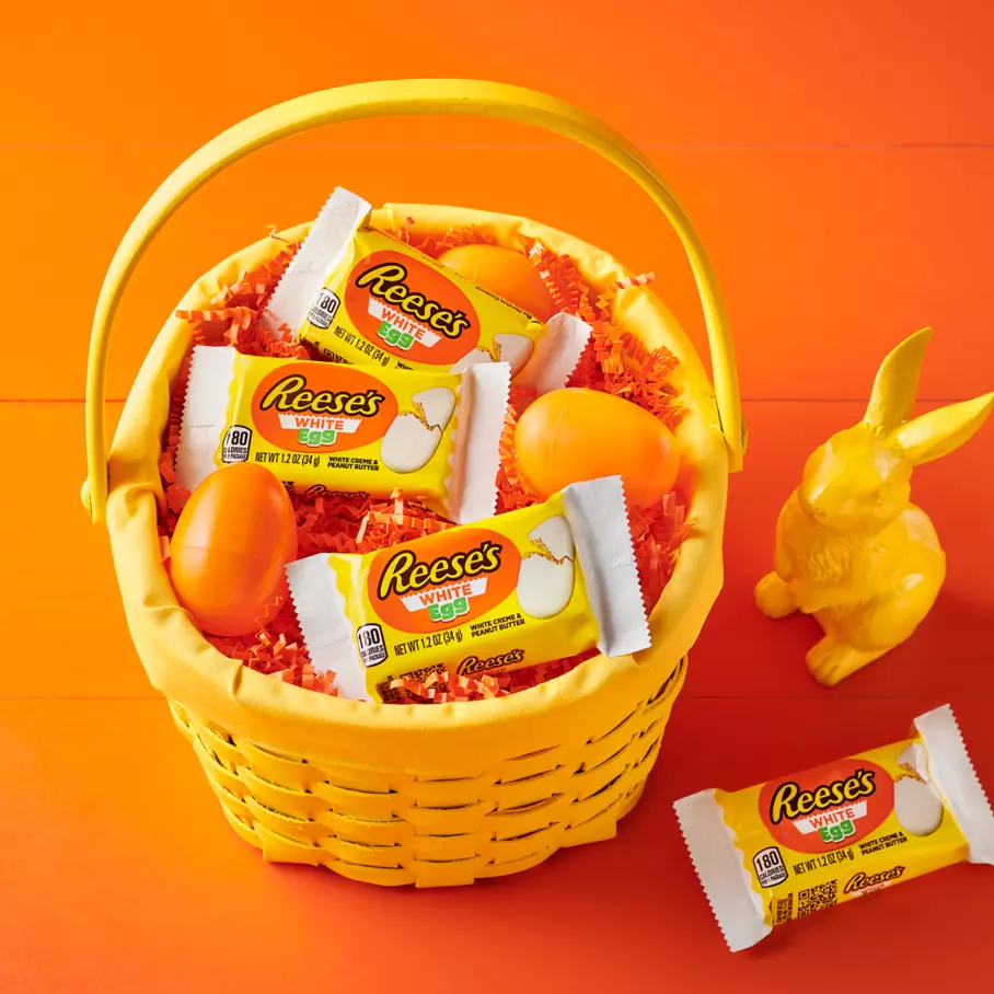 easter basket filled with packs of reeses white creme peanut butter eggs