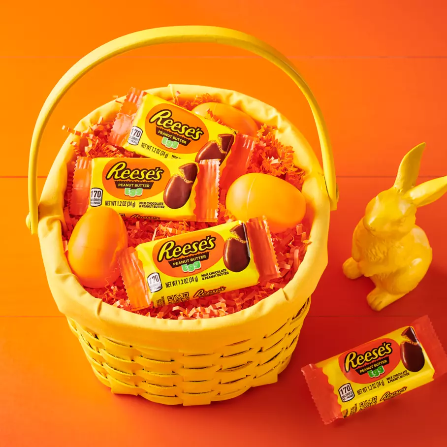 easter basket filled with packs of reeses milk chocolate peanut butter cups