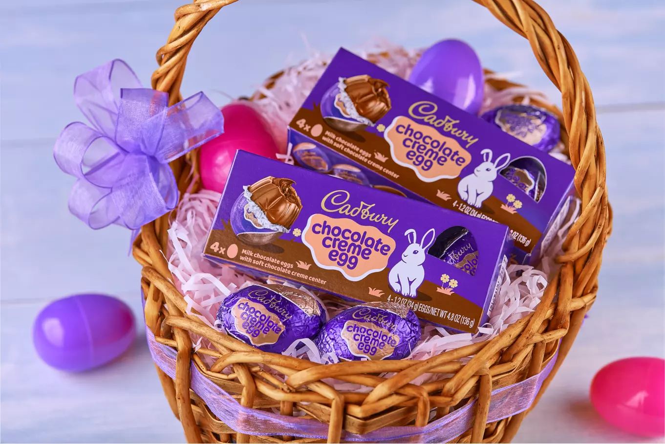 CADBURY CHOCOLATE CREME EGG Milk Chocolate Eggs inside Easter basket beside plastic Easter eggs