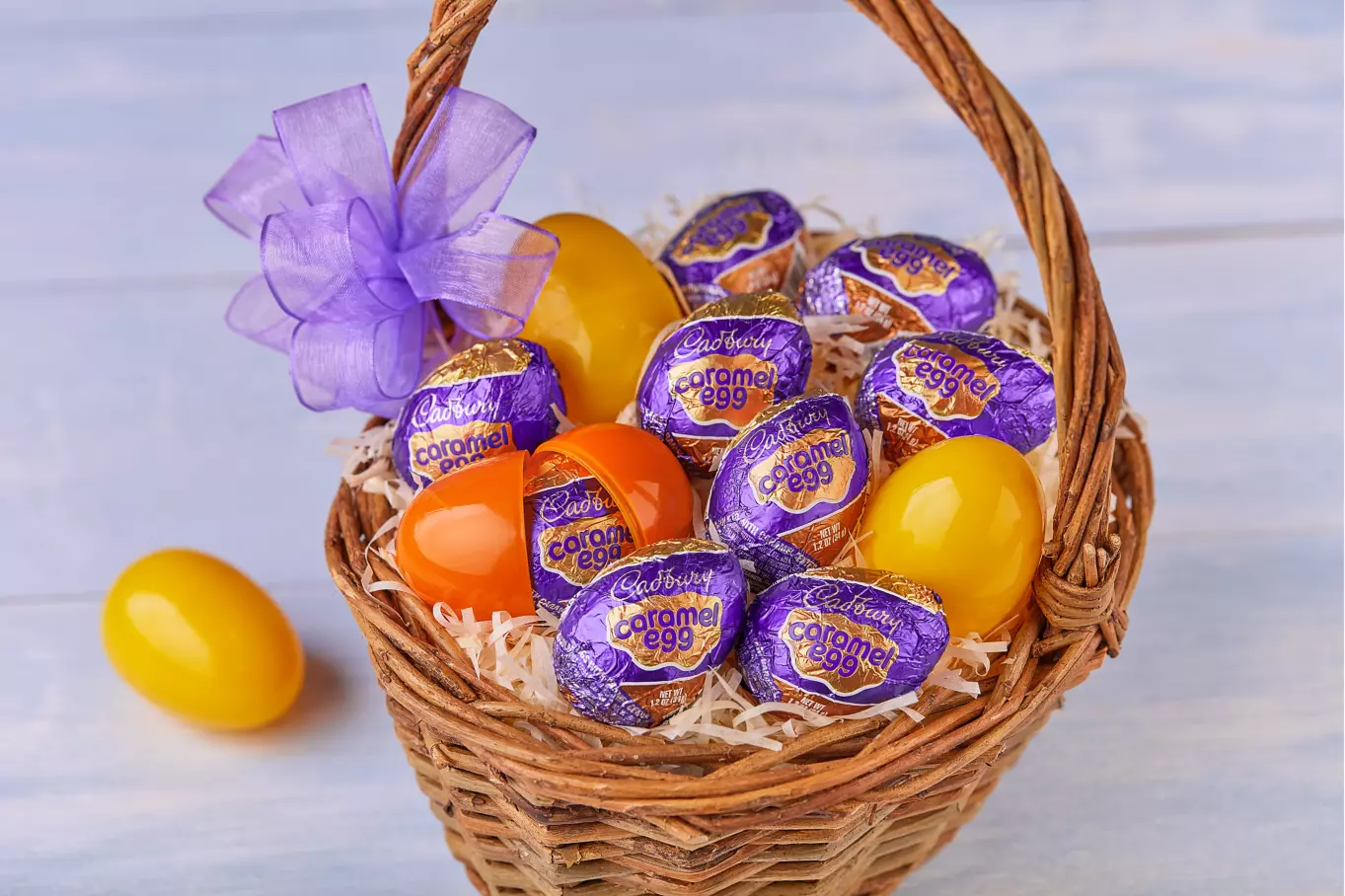 easter basket filled with cadbury caramel milk chocolate eggs and plastic eggs