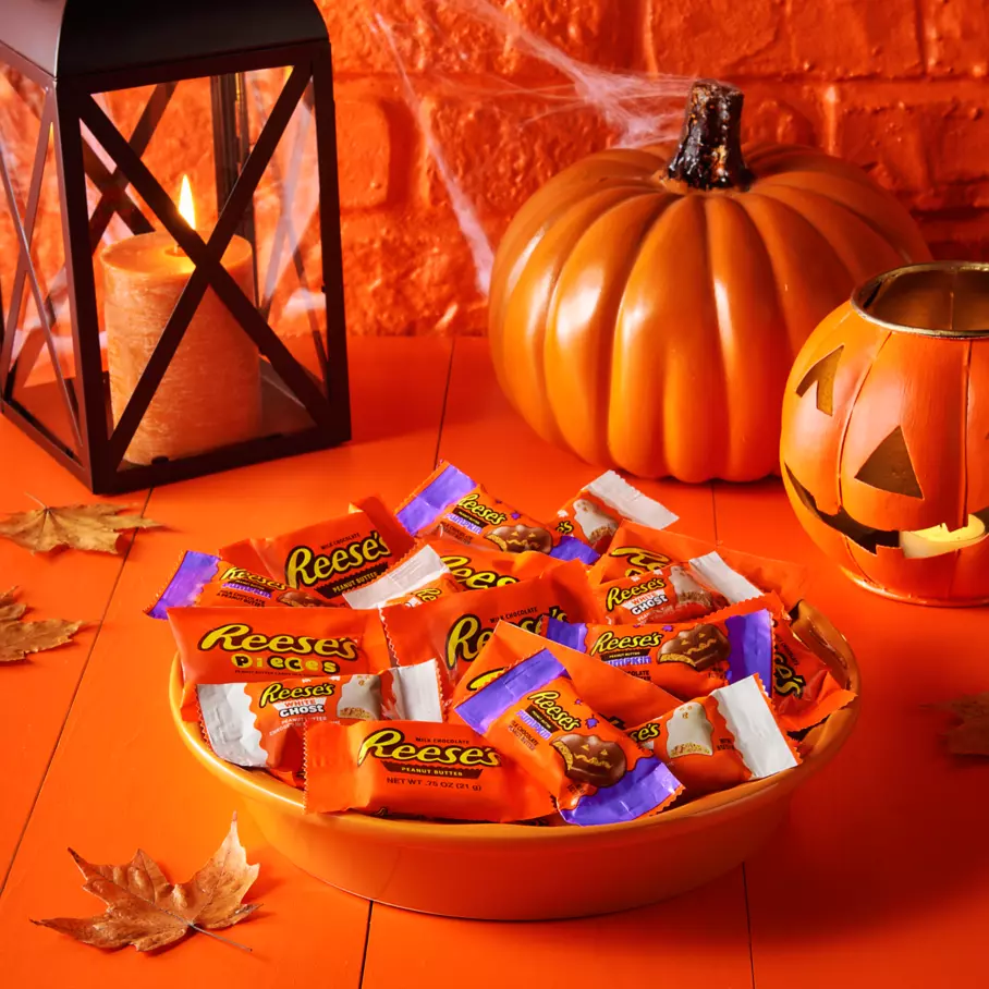 Bowl full of assorted reeses snack size candy on front porch