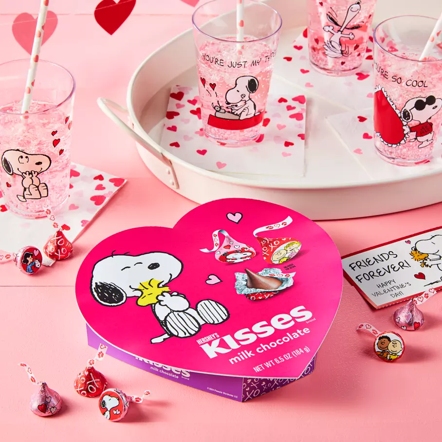 hersheys kisses snoopy and friends gift box beside tray of beverages and valentine cards