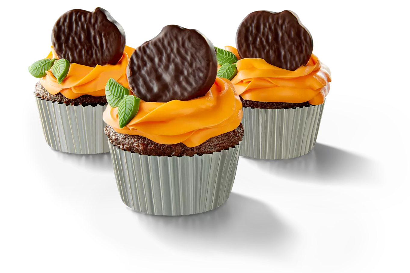 Chocolate cupcakes topped with orange frosting and york dark chocolate peppermint pumpkins
