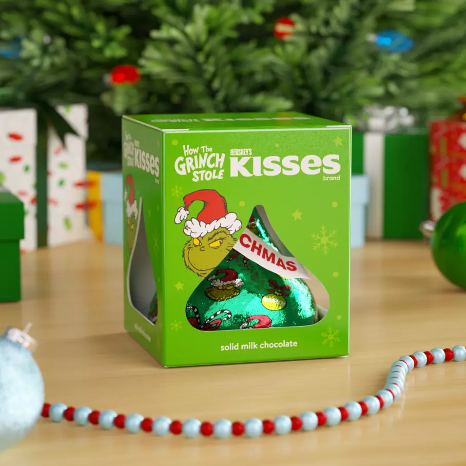 HERSHEY'S KISSES Grinch® box under the Christmas tree