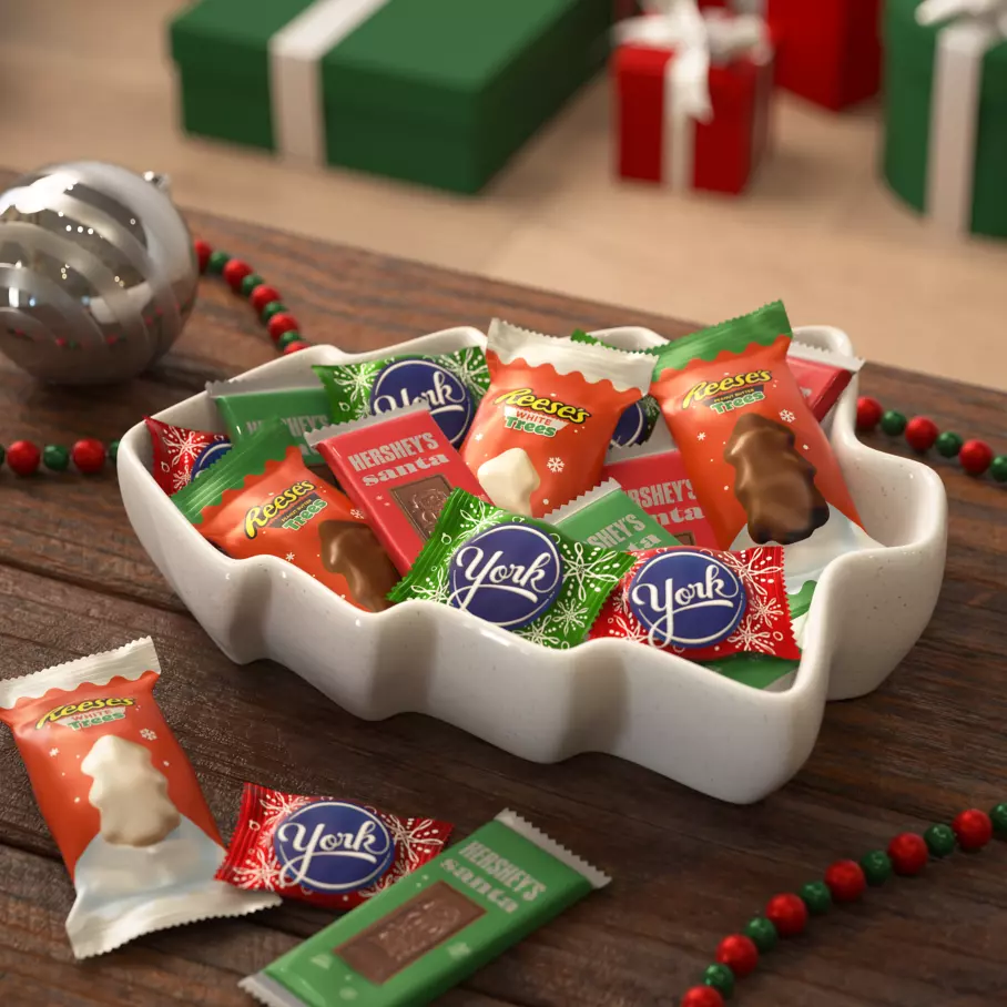 white tree bowl filled with assorted hersheys stocking stuffer shapes candy