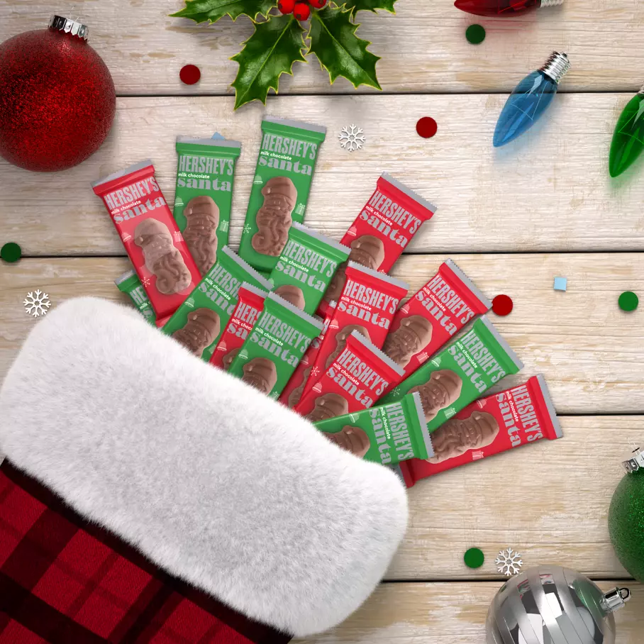 christmas stocking filled with red and green packs of hersheys milk chocolate santas