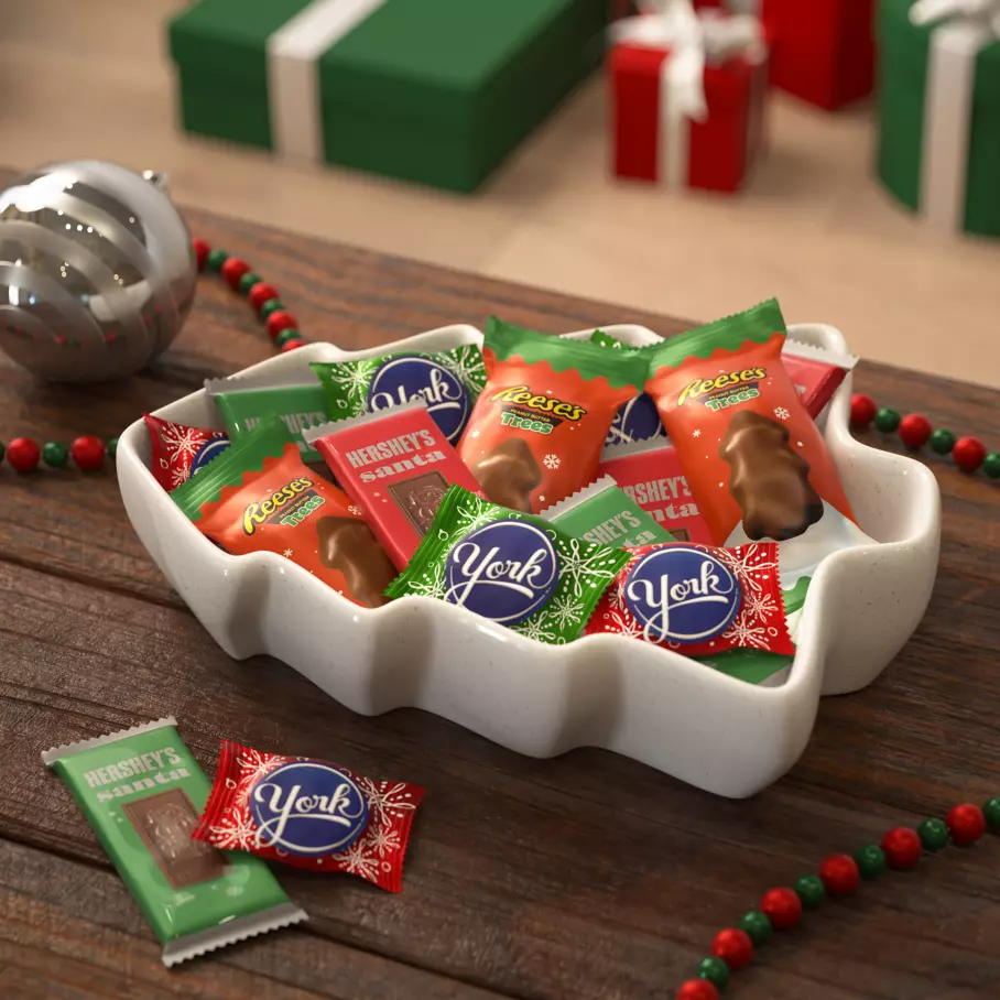 white tree bowl filled with assorted hersheys stocking stuffer shapes candy