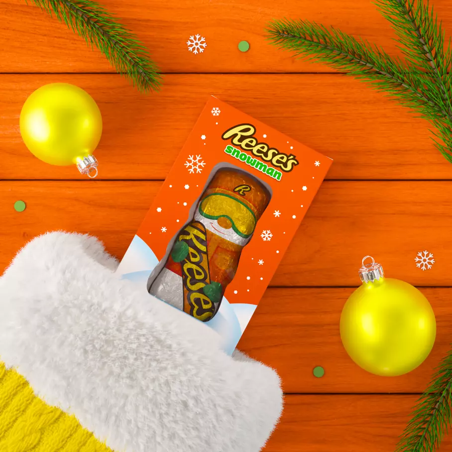 christmas stocking filled with box of reeses milk chocolate peanut butter snowman