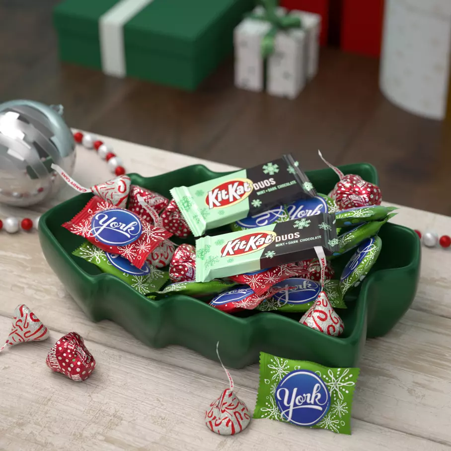dark green tree bowl filled with assorted hersheys holiday mint candy