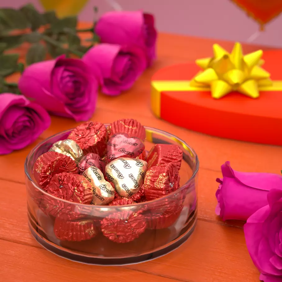 glass bowl filled with reeses hearts and miniatures milk chocolate peanut butter cups