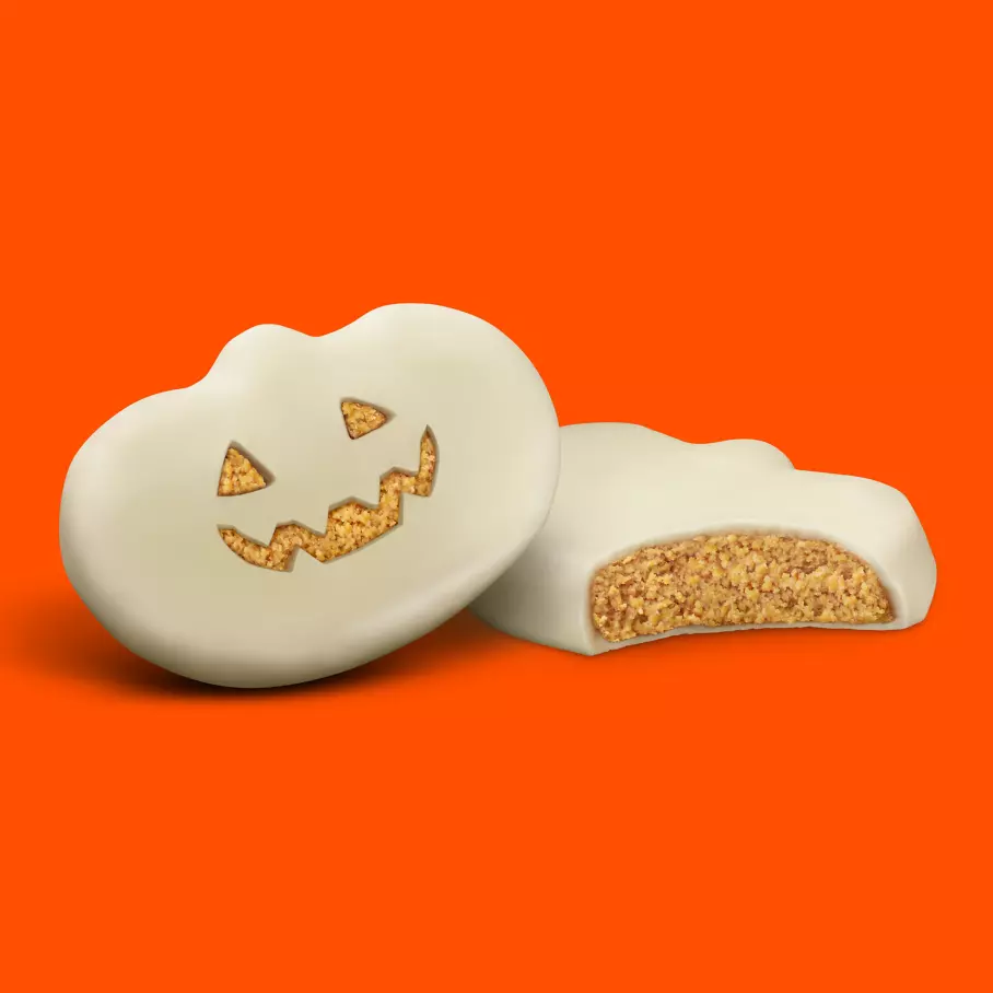 Pair of unwrapped reeses white creme peanut butter king size pumpkins