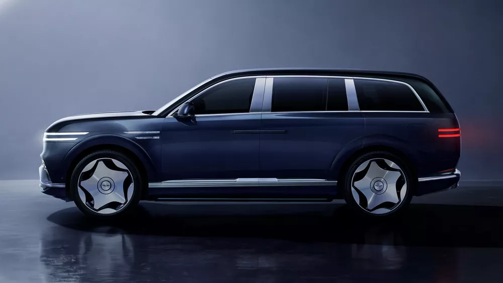 Driver-side profile view of 2028 Genesis GV90 luxury electric SUV in Sonoran Navy