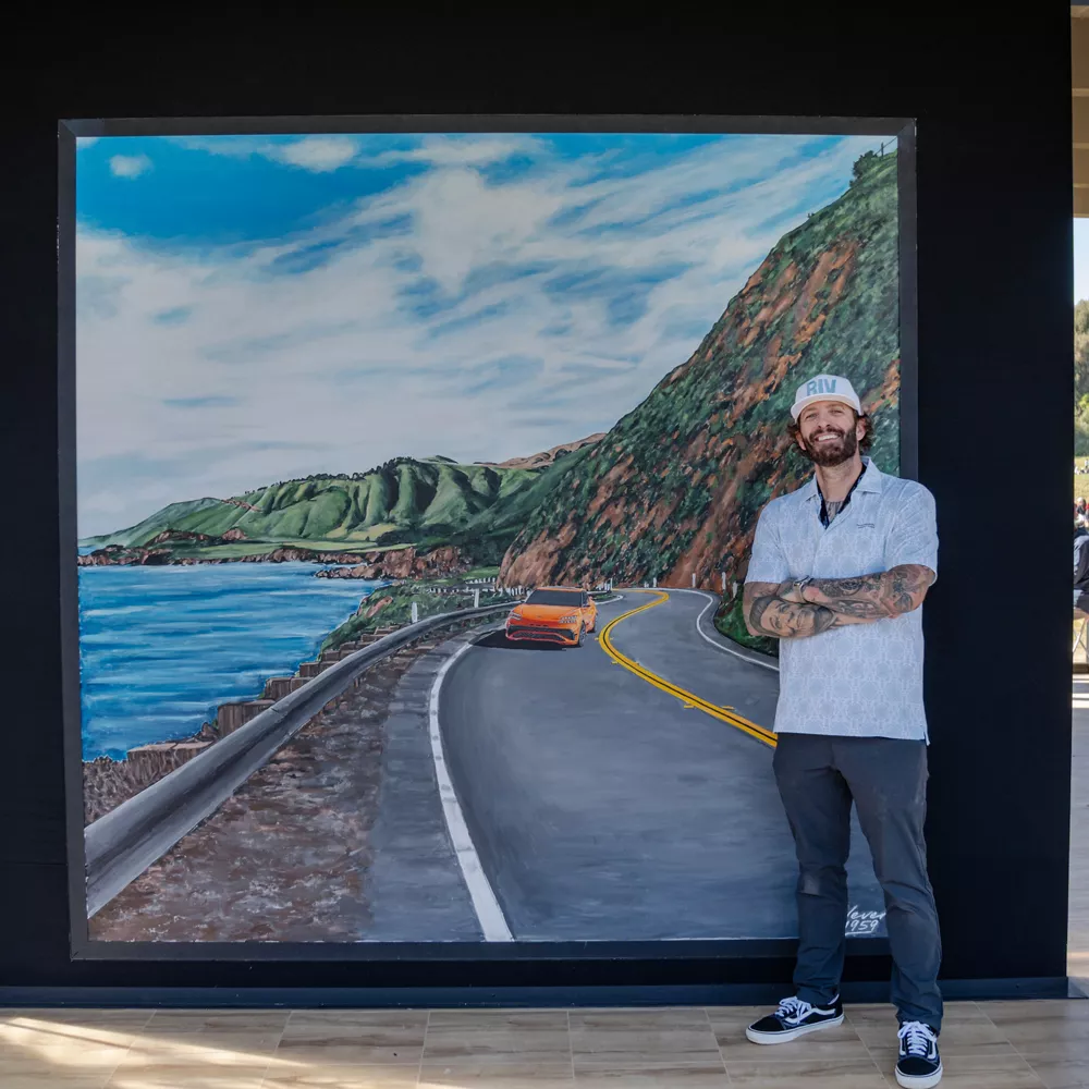 Muralist Jonas Never standing in front of original painting at 2026 Genesis Invitational