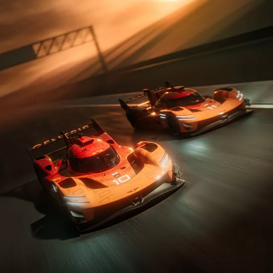 Aerial front facing view of two Genesis Magma Racing Hypercars driving side by side on racetrack